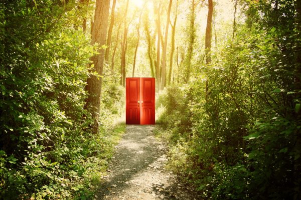 A,Red,Doorway,Is,On,A,Trail,In,The,Woods