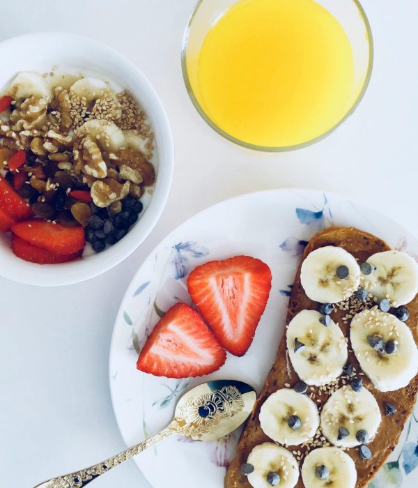 Nutritious breakfast with banana toast, fruit bowl, and orange juice, perfect for a healthy start.